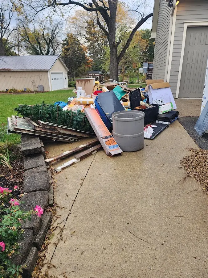Dumpster being loaded with debris for Commercial Dumpster Rental in Richmond West